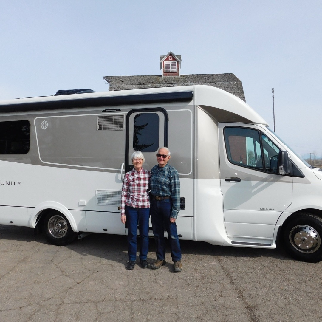 Van City RV customers standing with their Leisure Travel Van